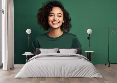 Portrait of funny young lady dressed casual t-shirt smiling on dark green background. Wall mural