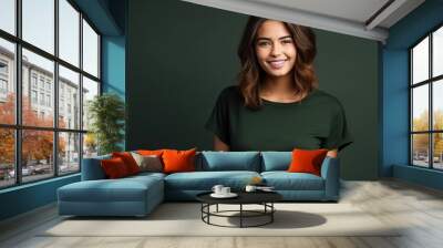 Portrait of funny young lady dressed casual t-shirt smiling on dark green background. Wall mural