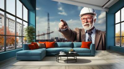 Senior male engineer pointing at construction site clean background  Wall mural