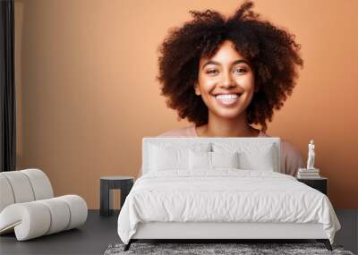 Smiling young black woman in casual attire against a clean background  Wall mural