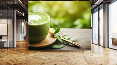 Top view Hot green tea latte with green leaves and wooden spoon  Wall mural