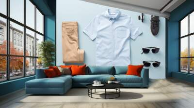 Top view Men's casual outfits with man clothing and accessories on, light blue background.  Wall mural