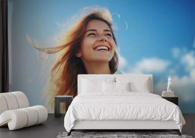 Young woman with a toothy smile With a bright sky background Wall mural