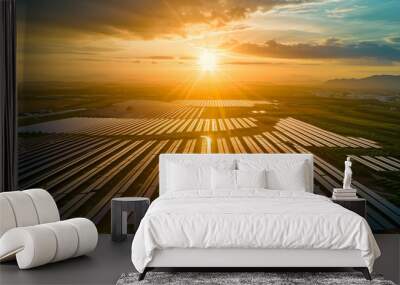 A bird's-eye view of a vast solar farm at sunset, the golden hour casting long shadows. Wall mural