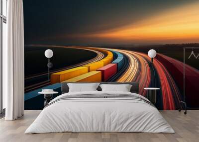 A train with a yellow and red car is traveling down a long, curvy road Wall mural