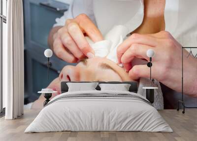 young woman having facial beauty treatment at beauty salon Wall mural