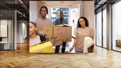 Family with teenage daughter and son entering new house with boxes Wall mural