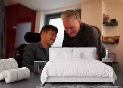 Father spending time with disabled son at home Wall mural