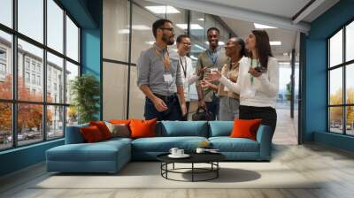 Group of office workers walking together in office corridor Wall mural