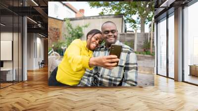 Mother and adult son with Down syndrome taking selfie Wall mural