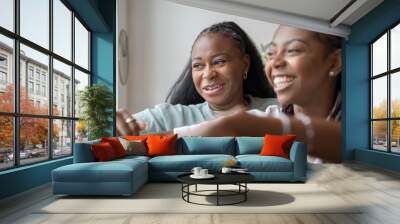 Portrait of happy lesbian couple at home Wall mural