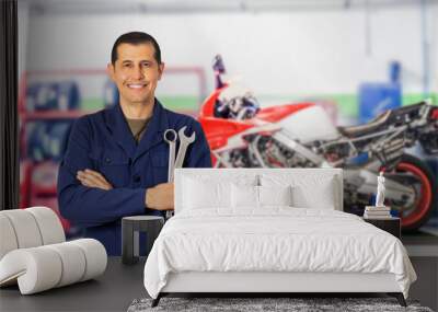 Front view portrait of a motorcycle mechanic posing standing looking at you in a mechanical workshop and copy space Wall mural