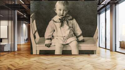 Latvia - CIRCA 1920-1925: A portrait of child sitting on wave bench in studio, Vintage Carte de Viste Art Deco era photo Wall mural