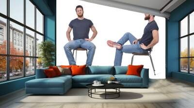 front and side view of same man sitting on chair on white background Wall mural