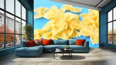 Pasta farfalle on blue background Wall mural