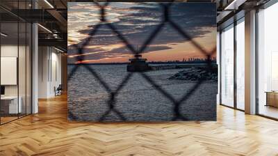 sunset in the city behind fence Wall mural