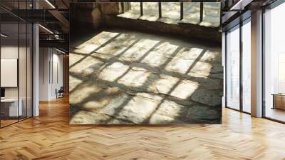 Shadows cast by window frames on a stone indoor floor captured in a shallow depth of field Wall mural