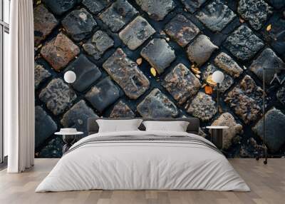 A black and gray stone wall with a leaf on it Wall mural