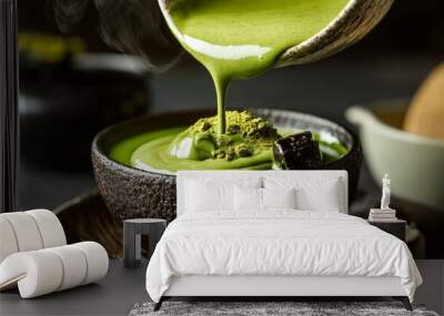 A bowl of green food with a spoon pouring it out Wall mural