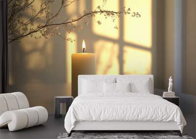 A candle is lit on a table in front of a window Wall mural