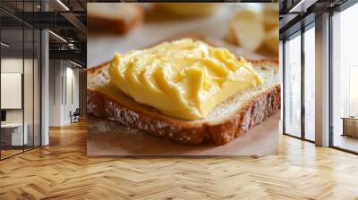 A slice of bread with a spread of yellow butter on top Wall mural