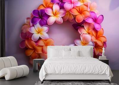 A colorful flower lei made of pink, purple, and orange plumeria blossoms. Wall mural