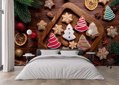 A festive holiday platter filled with an assortment of beautifully decorated Christmas gingerbread cookies. The platter on a rustic wooden table adorned with Christmas decorations for a warm Wall mural