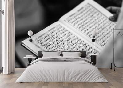 Reading Quran in hand - holy book of Muslims, black and white photo Wall mural