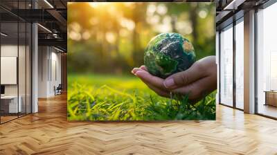 Hand holding earth on green grass, ESG, Environement care Wall mural