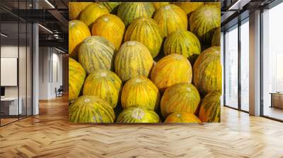 Closeup view of bright yellow and green melons for sale on a market in Tajikistan, Central Asia Wall mural