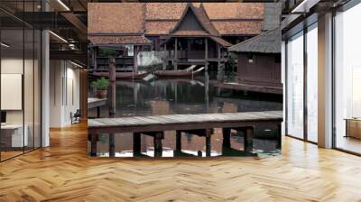 Peaceful thai floating architecture with traditional wooden house and bridge in Ancient City, Thailand, Asia Wall mural