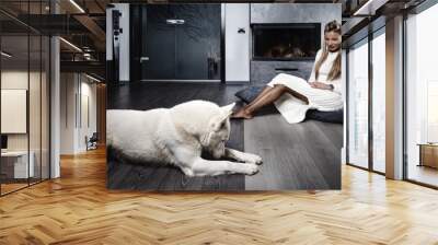 Elegant woman near the fireplace with a dog Wall mural