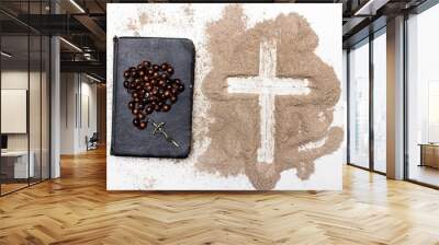 Old Bible, rosary and Cross of ash on white background - symbols of Ash Wednesday. Wall mural