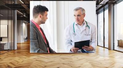 senior doctor consults young patient Wall mural