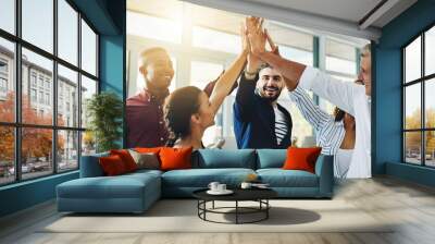 Corporate businesspeople celebrate success in an office. Passionate people feeling motivated, confident and cheerful. Excited, smiling and diverse professional group happy with their big win. Wall mural