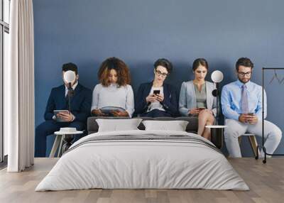 Group of business people at a job interview at a small startup company with copy space. Businesspeople sitting and waiting in line for a meeting with human resources and applying for work Wall mural