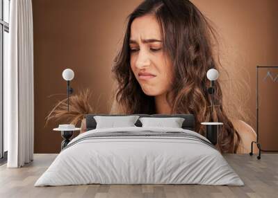 Beauty, crisis and sad woman in studio with hair loss, dry and damage against brown background. Haircare, fail and girl model frustrated with weak, split ends or alopecia while posing isolated Wall mural