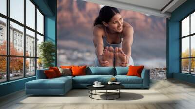 Fitness, yoga and stretching with a woman on the beach for wellness, mental health or exercise in nature. Environment, peace and thinking with a female athlete doing a warm up for zen training Wall mural