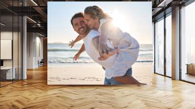 Happy, couple and piggyback walk on the beach for love, travel or summer vacation bonding together in the outdoors. Man carrying woman on back with smile enjoying playful fun time walking by the sea Wall mural