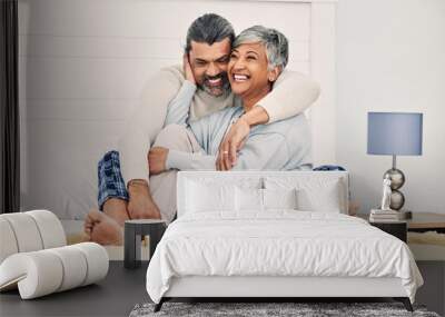 Hug, happy or old couple in bed to relax, enjoy romance or morning time together at home in retirement. Embrace, senior woman or funny elderly man laughing or bonding with love, support or smile Wall mural