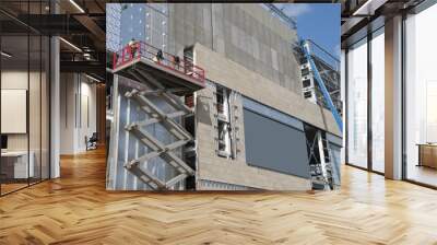 A Scissor Lift  and a cherry picker on a construction site Wall mural