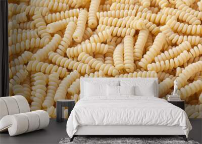 Uncooked fusilli corti bucati pasta background Wall mural