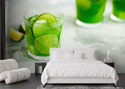 Homemade trendy iced matcha green tea or lemonade with cucumber and lime in a glass on light gray background with copy space for text.Healthy cold vegan beverage for hot summer day.Super food drink Wall mural