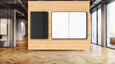 Black closed and open lined notebooks on wooden background Wall mural