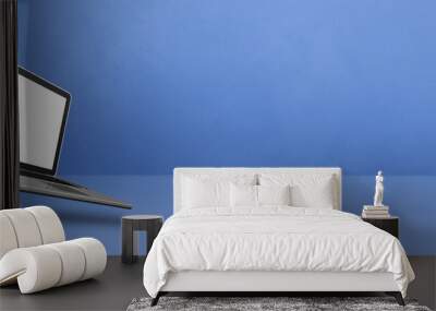 Floating computer laptop isolated on blue. Horizontal banner background Wall mural