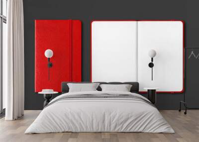 Red closed and open notebooks isolated on black Wall mural