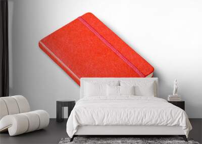 Red closed notebook isolated on white Wall mural