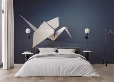 White paper crane origami isolated on a grey background Wall mural