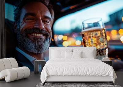 A bearded man with a broad smile enjoys holding a champagne glass in a luxurious car, reflecting the essence of relaxed nightlife and urban sophistication. Wall mural