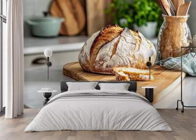 A delectable loaf of freshly baked artisanal bread sitting on a wooden cutting board under natural lighting, embodying the warmth and comfort of homemade baking. Wall mural